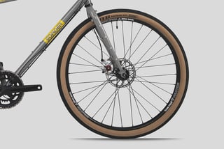 Front wheel of the Sonder Santiago fitted with a tan-wall WTB Horizon 47c tyre, showing fork clearance.