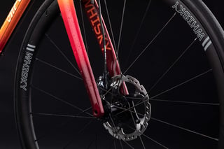 Whisky carbon fork and disc brake on the orange-red fade All-City Zig Zag, with Whisky rims.