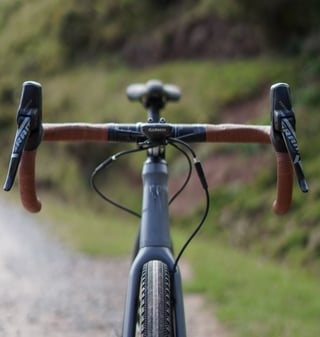 Front view of the Trek Crockett's drop bar with brown tape, SRAM Force levers and a Garmin computer mount.