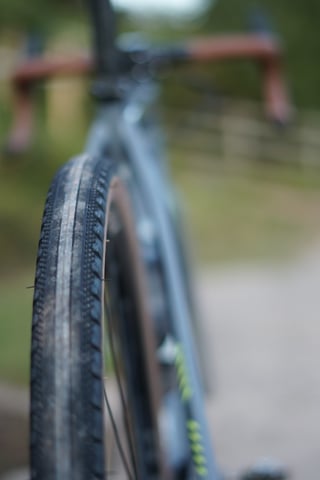 Tread of a WTB tyre on the Trek Crockett in sharp focus, with the frame and brown drop bars blurred behind it.