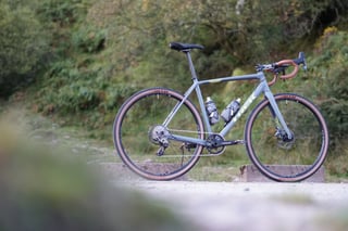 Unloaded Trek Crockett 7 in grey with lime graphics, WTB tyres and a black saddle, set against green woodland.