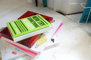 Stack of design books on the studio floor at Straight Cut, Edinburgh, including Now Try Something Weirder.