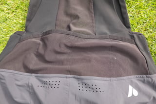 Close-up of the four elasticated rear pockets on the Ignite 2-in-1 bib, above the outer short's laser-cut vent holes.