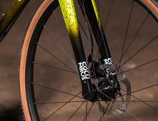 Columbus carbon fork on the All-City Macho King with a flat-mount disc brake and thru-axle at the front wheel.