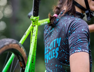 Green Nature Boy with Team Edition decal shouldered by a rider in a splatter-print All-City Cycles jersey.