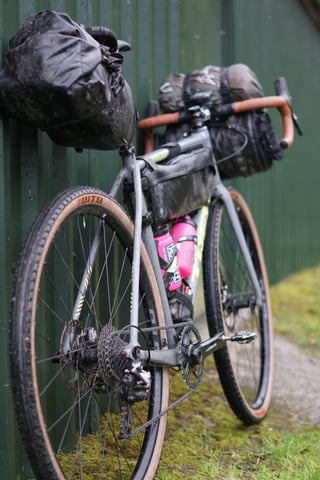 Trek Crockett on WTB Byway 44 tyres, loaded with bikepacking bags and propped against a green wall for the Wildcat 100.