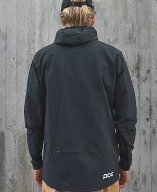 Model seen from behind in the black POC Mantle hoodie, showing the hood, rear zipped pocket and logo at the hem.