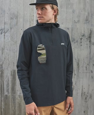 Model wearing the POC Mantle hoodie with mirrored sunglasses tucked into the chest glasses holder.
