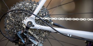 Rear dropout of the Cosmic Stallion with All-City logo, SRAM Force rear derailleur and cassette.
