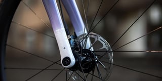 Columbus Futura Cross fork end on the Cosmic Stallion, fading to white, with thru-axle and front disc brake rotor.