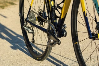 Low drive-side close-up of the Wish One SUB showing the navy and yellow frame, 1x drivetrain and Mavic wheels.