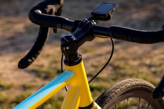 Wish One SUB cockpit with an ENVE stem, drop bars and a bike computer above the yellow head tube.