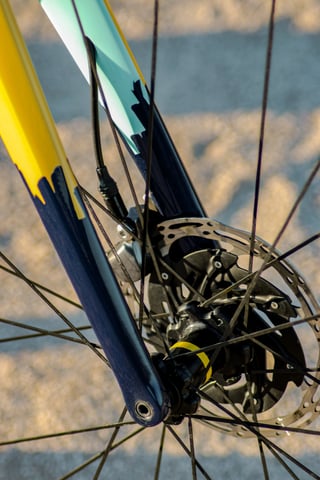 Columbus Futura carbon fork on the Wish One SUB with the disc brake caliper and rotor seen through the front spokes.