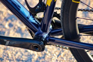 Wish One SUB bottom bracket in navy with a SRAM Force crank arm and Mavic wheel beside the chainstay.