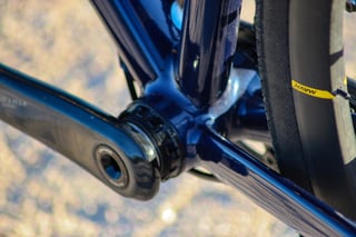 Wish One SUB bottom bracket and crank arm in gloss navy paint, with the Mavic rear wheel alongside.