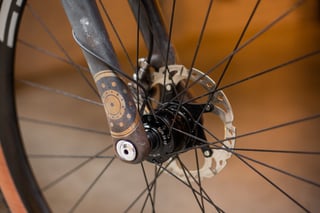 Son 28 dynamo front hub and disc rotor on the A.T.E.R., with a rust-and-gold gear motif painted on the fork leg.
