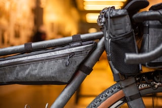 Cordel frame bag and bar-mounted food pouch on the A.T.E.R., with the Vittoria Terreno front tyre below.