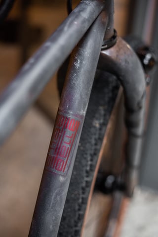 Red Belle Cycles decal on the down tube of the A.T.E.R., with the fork crown and Vittoria tyre behind.