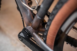 Bottom bracket and chainstay of the Belle Cycles A.T.E.R., with the weathered, rusty paint finish and Ingrid crank arm.