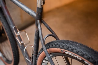 Seat stays, seat tube and rear tyre of the Belle Cycles A.T.E.R. with a titanium seat mast, King Cage bottle cages behind.