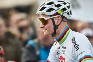 Close-up of Mathieu van der Poel in rainbow-striped Alpecin-Fenix kit, Lazer helmet and gold-lens glasses at Hoogerheide.