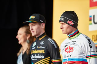 Mathieu van der Poel in the rainbow jersey on the Hoogerheide World Cup podium beside a Telenet Baloise rider.