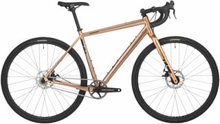 Complete Salsa Stormchaser singlespeed in gold with RaceFace crank, Teravail Rutland tyres and drop bars, side view.