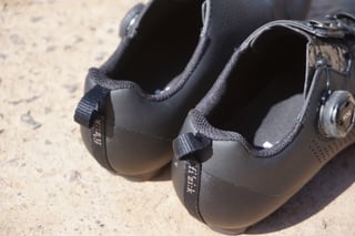 Heels of a pair of Fizik Terra X5 shoes, with pull tabs, fizik branding and the BOA dial.