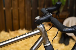 ENVE stem and drop bars on the Bingham Built Adventure, with titanium frame and bolt-on mounts on the top tube.