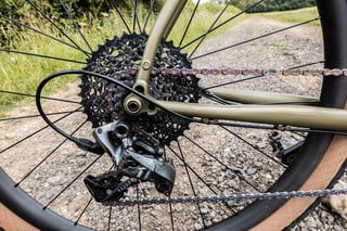 SRAM Force 1 rear derailleur and cassette on the Bombtrack Hook EXT, with an oil-slick chain.