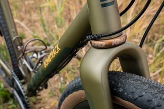 Chris King headset in bourbon and Bombtrack down tube logo on the Hook EXT's olive steel frame.