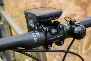 Close-up of the Ritchey C220 stem and Wahoo computer mount with the bell beside it.