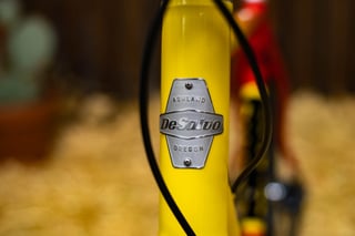DeSalvo head badge reading Ashland, Oregon on the yellow head tube of the DeSalvo Gravel.