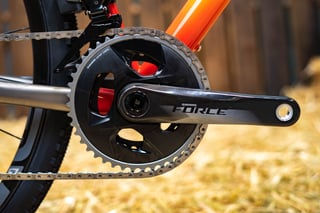 SRAM Force crankset and double chainrings on the red and orange frame of the DeSalvo Gravel.