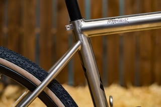 Close-up of the signed titanium top tube and seat cluster on the Holland Cycles Gravel at the ENVE Builder Round-Up.