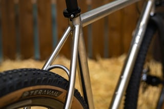 Seat cluster of the Horse Cycles Monster Gravel in polished stainless steel, with a Teravail tan-wall rear tyre.