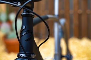 Matte black head tube of the Sklar All Road with Chris King headset and a cable looped in front.