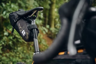 Straight Cut Design saddle bag in Multicam on the Fairlight Faran 2, with the handlebar blurred in the foreground.