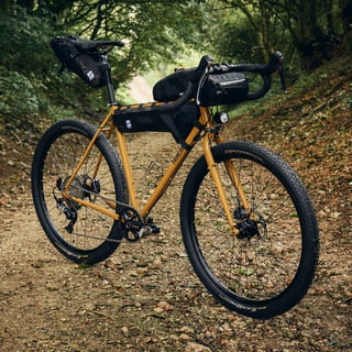 Fairlight Faran 2 in Winter Bracken with Straight Cut Design bags and Continental Race King tyres on a woodland track.