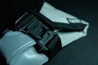 Wiz Viz Lil Presto! barrel bag on a black background, fluro orange at one end and reflective grey along the body.