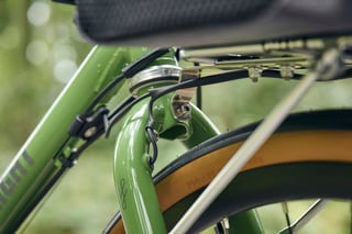 Nitto M18 front rack and fork crown on a Woodland Green Fairlight Faran 2 with tan-wall Panaracer tyre.