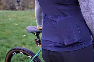 Close-up of the rear pockets on the Velocio Micromodal long sleeve jersey, with a small reflective strip beside them.