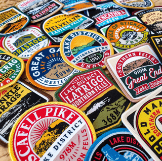 Adventure Patch Company embroidered Lake District fell patches, including Scafell Pike, Helvellyn and Latrigg, with heights.