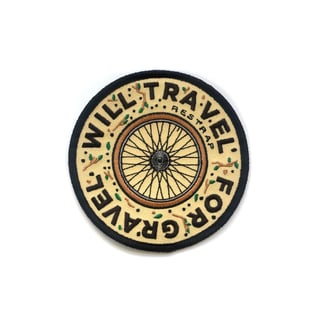 Restrap embroidered patch with a bicycle wheel, reading 'Will travel for gravel'.
