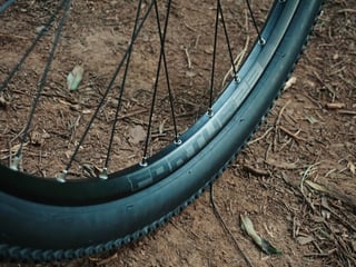 Hope Fortus 23 rim with black spokes and a Panaracer 27.5 x 2.00 tyre on the Planet X Tempest.
