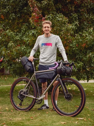 Peter Rutherford of Aravis Bag Works stands with a Red Fox Cycles bike loaded with his handmade bags.