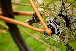 3D-printed rear dropout and disc rotor on the copper Quirk Superchub, with SRAM calliper and gold cassette.