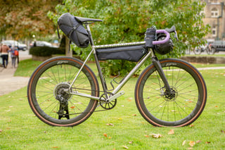Red Fox Cycles gravel bike with Aravis Bag Works saddle, frame and handlebar bags and purple bar tape.