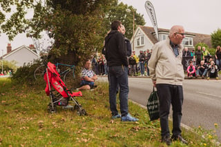 Spectators wait on the verge by the Hambro Hill climb ahead of the Women's Tour of Britain, a pushchair among them.
