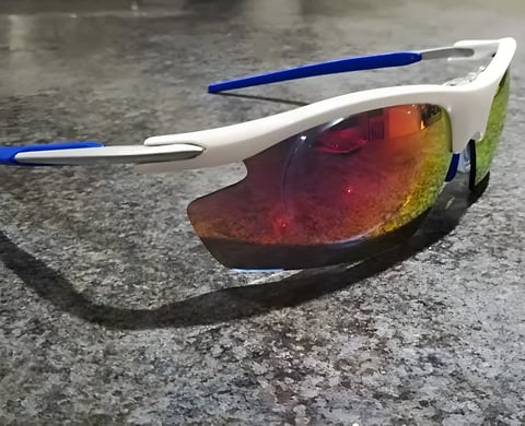 Optilabs Swift varifocal cycling glasses with a white frame, blue arms and red-mirrored shield.